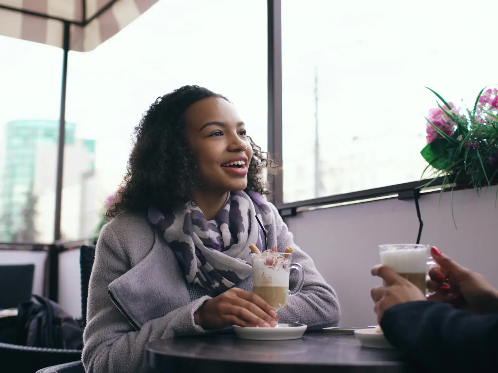 Two people talking together over coffee in a cafe